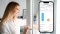 The image shows the Savings Assistant app screen with a woman at the window in the background.